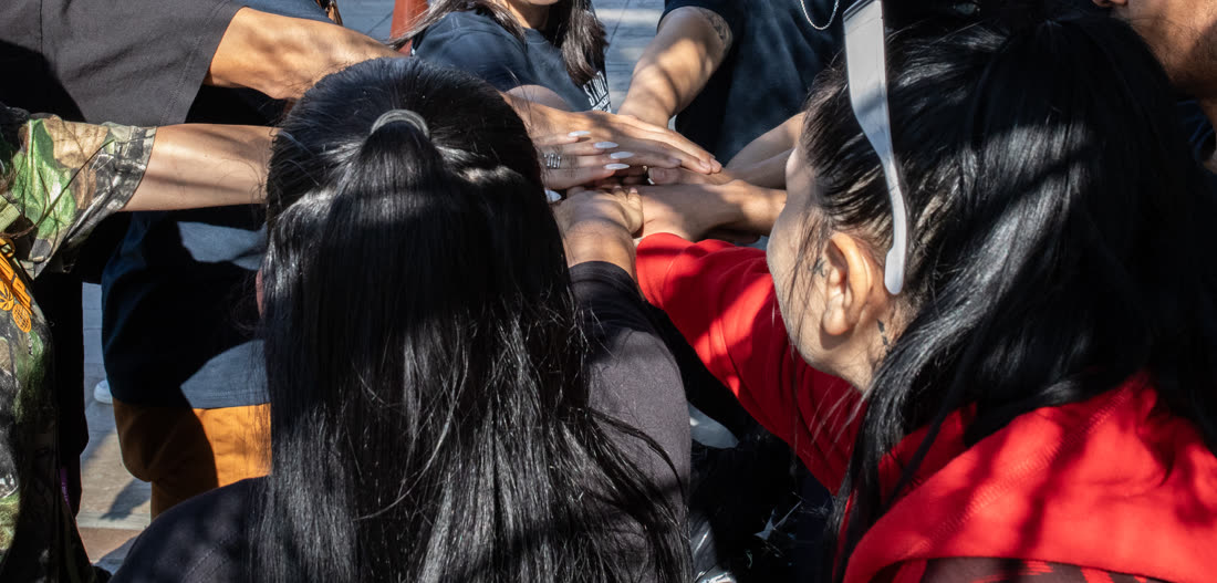 STIIIZY team members putting their hands in together